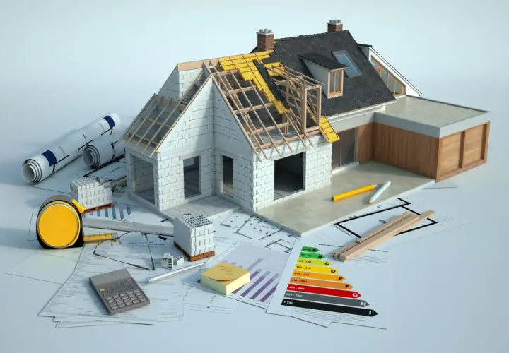Model domu w budowie, plany, materiały budowlane i kalkulator. Trwa dobudowa do domu, planowanie i realizacja.